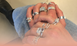 hands with several unique silver rings